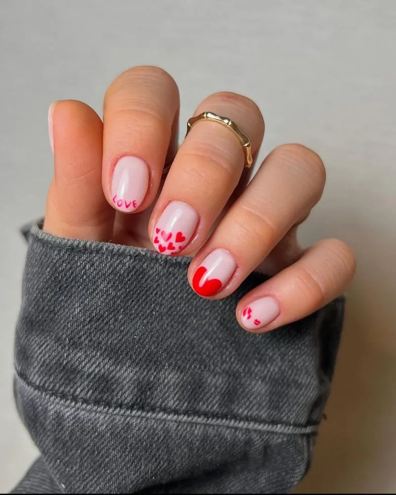 Romantic heart nail art idea, A charming nail design featuring tiny, delicate hearts for a sweet look.
