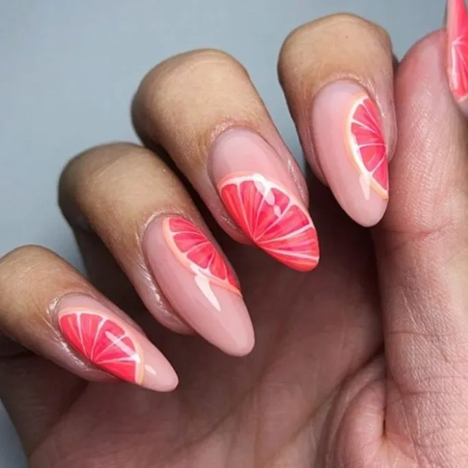 Vibrant grapefruit-inspired nail art for a fresh summer look!