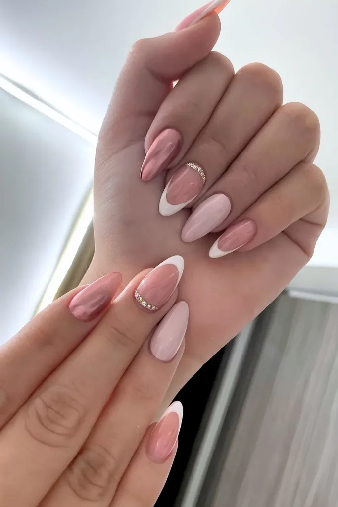 Pink and white French manicure with rhinestone accent.
