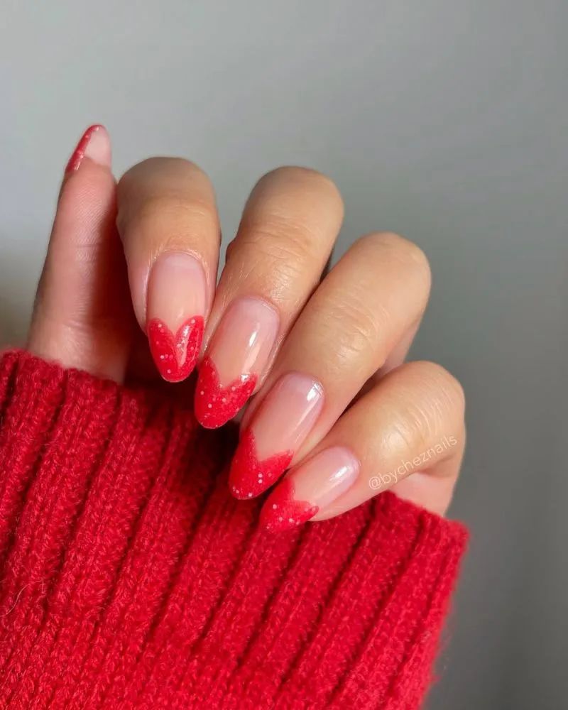 A unique nail design featuring tips shaped like tiny hearts for a romantic vibe.