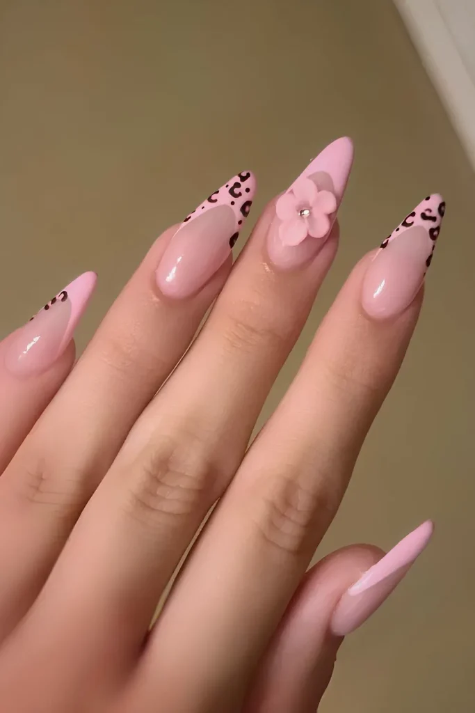 stiletto-shaped nails with a glossy, nude-pink base.