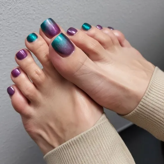 Mesmerizing ombre pedicure with a stunning gradient blend of purple and teal.