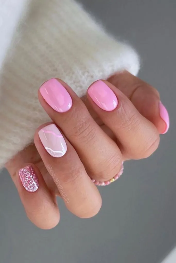 Pink nails with white accent and glitter nail.