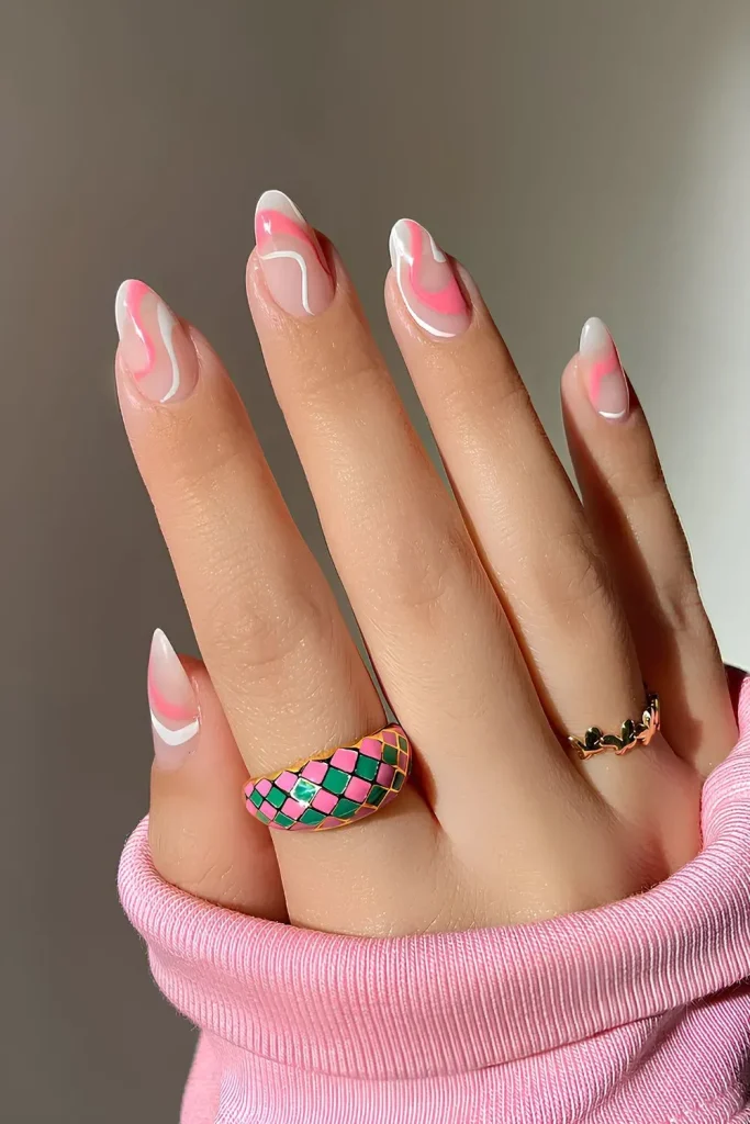 swirly nails feature a playful and modern design with a mix of pink, white, and nude tones.